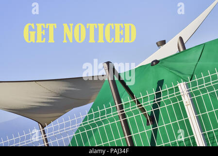 Text Get Noticed written on a background with interesting shapes Stock Photo