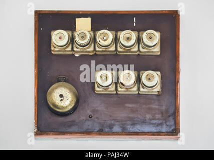 Several old fuses on a home electric board on the wall Stock Photo