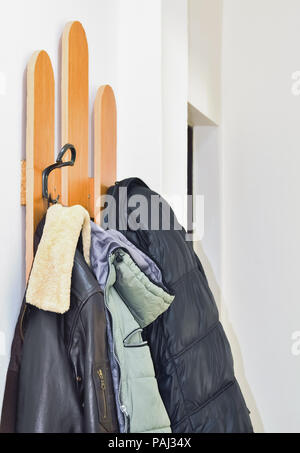Domestic hat stand with several jackets hanging on it Stock Photo