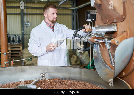 Worker Roasting Coffee Stock Photo