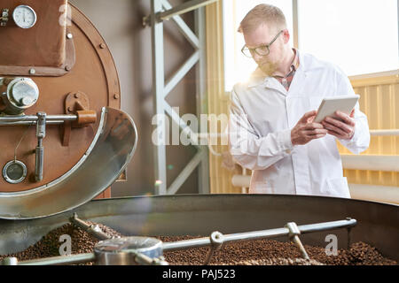 Worker Roasting Coffee at Factory Stock Photo