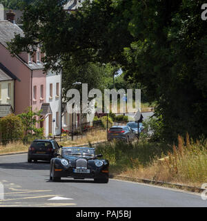 Moretonhampstead small town in the Dartmoor National Park, Devon, England, UK. A Morgan Aero driving  in foreground Stock Photo