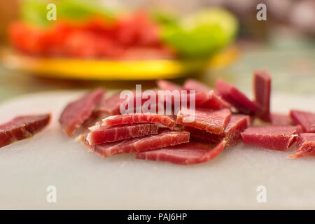 Sliced domestic ham on a kitchen table. Stock Photo
