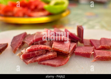 Sliced domestic ham on a kitchen table. Stock Photo