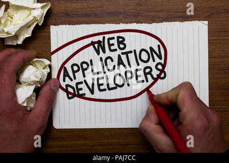 Text sign showing Web Application Developers. Conceptual photo Internet programming experts Technology software Hand hold paper lob and red pen red ci Stock Photo