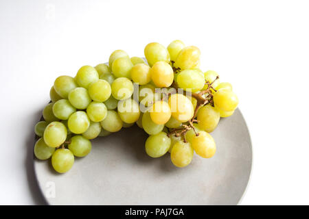 Ripe grape fruit isolated on grey concrete plate close up Stock Photo