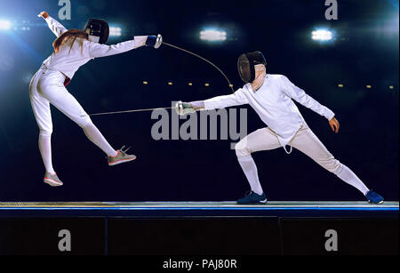 Two fencing athletes fight on professional sports arena Stock Photo