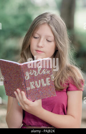 Pre teen girl outdoors Stock Photo