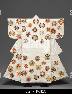 Noh Costume (Nuihaku) with Scattered Crests. Culture: Japan. Dimensions: Overall: 65 x 53 1/2 in. (165.1 x 135.9 cm). Date: second half of the 18th-19th century.  There are over twenty different crests of varying size on this robe. Some of the designs have Buddhist significance, such as the manji (reverse swastika) and the circular "wheels of Buddhist law." Others have auspicious symbolism or are purely decorative. These colorful crests with gold-leaf backgrounds (monzukushi) are customarily embroidered on white, black, red, or indigo Noh costumes made from satin. These costumes, called Nuihak Stock Photo