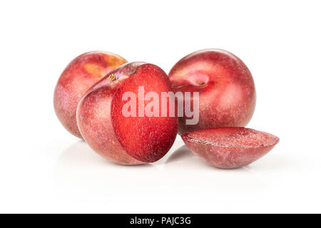Group of two whole two halves of fresh pluot interspecific plums variety one sliced isolated on white Stock Photo