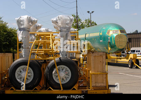 main undercarriage legs and wheels with a Boeing 737-700 fuselage (LN2350) on a trolley outside the production factory Stock Photo