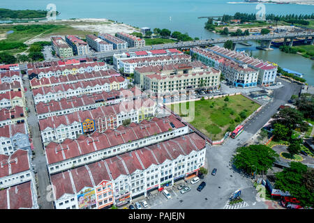 Overhead view of rows of colourful and white historical dutch colonial terraced houses in Melaka, Malaysia behind is a road bridge spanning the estuar Stock Photo