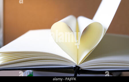 close up heart shape from paper book on book stack with copy space background for text. Stock Photo