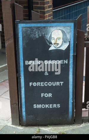 Humorous board for pub garden at The Shakespeares Head pub in Islington, London, showing playwright William Shakespeare with a cigarette in his mouth Stock Photo