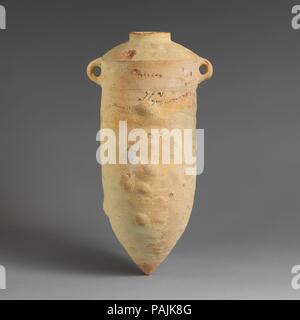 Terracotta amphora with Phoenician inscription. Culture: Cypriot. Dimensions: H.: 22 3/4 in. (57.8 cm). Date: 6th-5th century B.C..  There is a painted inscription of three lines: at top, Baalpilles, probably the name of the owner; below, Yaton, inspector.  Production of such Phoenician amphorae appears to have taken place on Cyprus, but finds at shipwrecks sites show that they were widely dispersed thoughout the eastern Mediterranean. Museum: Metropolitan Museum of Art, New York, USA. Stock Photo