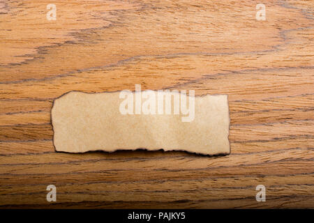 Piece of torn paper placed on plain background Stock Photo