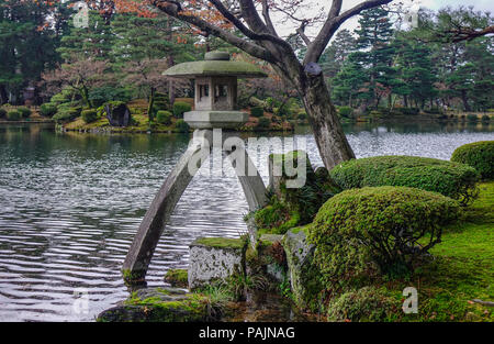 Famous Kotoji stone lantern beside pond at Kenrokuen garden in Kanazawa ...