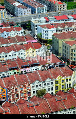 Overhead view of rows of colourful and white historical dutch colonial terraced houses in Melaka, Malaysia behind is a road bridge Stock Photo