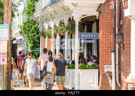 groups of people walking on the sidewalk in front of the American Hotel in Sag Harbor, NY Stock Photo