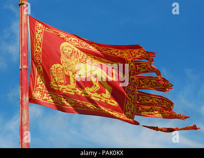 Old Venice Republic Flag with Saint Mark Lion fluttering in the wind Stock Photo