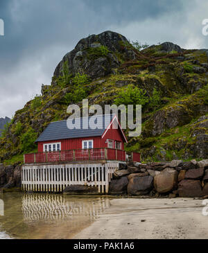 House on the shore of a fjord, Kabelvag, Lofoten Islands, Norway. Stock Photo