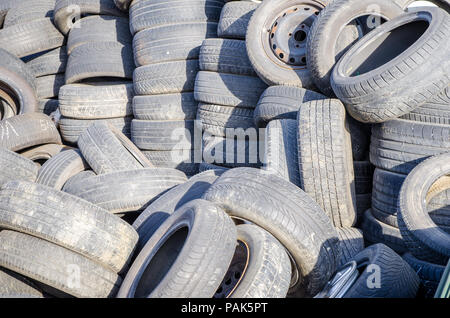 Pile of used old tires on a sunny day suggesting automotive trash Stock Photo