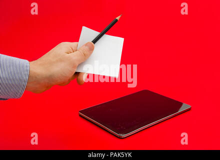 Paper notes and a pencil in comparisson with a modern high tech expensive tablet with a broken display touch screen on a red alerted serious important Stock Photo