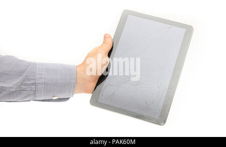 Broken cracked tablet touch screen glass display in a business man hand on a white background suggesting fix and repair services under warranty and th Stock Photo
