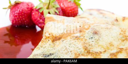 Close up of pancake texture with red strawberries and sauce on the background suitable for a menu background Stock Photo