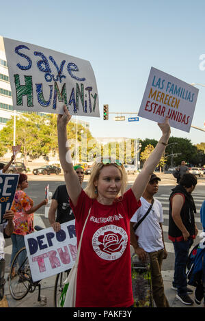 Los Angeles, USA - July 23 2018: Protestors rally outside LAPD headquarters while Incumbent L.A. County Sheriff Jim McDonnell and retired Lt. Alex Villanueva engaged in a contentious debate Monday in downtown Los Angeles on July 23rd, 2018 A female protestor hold 'save our humanity' and 'Fam'l'es Belong Together' signs.(Credit: Aydin Palabiyikoglu/Alamy Live News Stock Photo