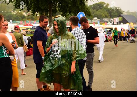 Builth Wells Wales UK, Tuesday 24 July 2018  UK Weather: People sheltering from the rain at the Royal Welsh Show, the UK’s leading agricultural event   photo © Keith Morris / Alamy Live News Stock Photo