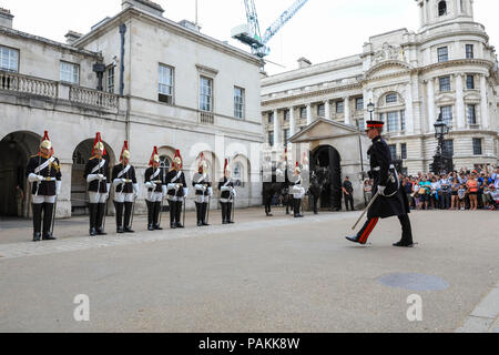 London, UK, 24th July 2018. Tourists watch members of the Blues and Royals at Horse Guards Parade in London's Whitehall for the Final Inspection of the day with the Household Cavalry's horses and uniformed soldiers. Credit: Imageplotter News and Sports/Alamy Live News Stock Photo