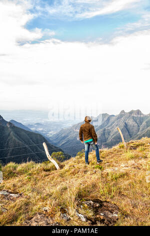 Young man looking to the landscape at Ronda Canyon, in Rio do Rastro Mountains (Serra do Rio do Rastro). Stock Photo