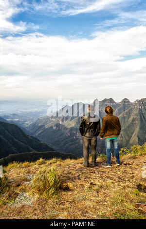 Father and son looking to the landscape at Ronda Canyon, in Rio do Rastro Mountains (Serra do Rio do Rastro). Stock Photo