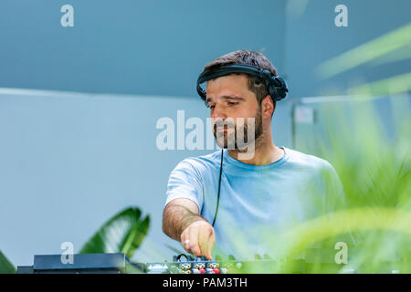 Photo of adult dj working with his equipment Stock Photo