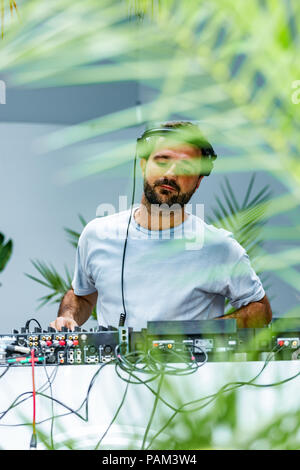 Photo of adult dj working with his equipment Stock Photo