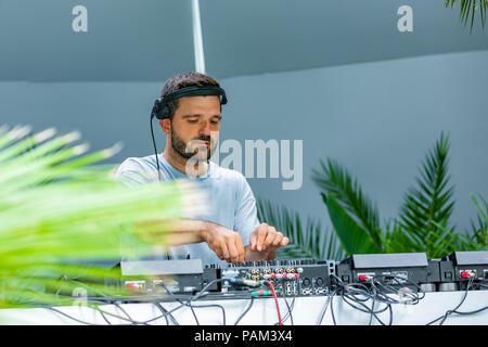 Photo of adult dj working with his equipment Stock Photo