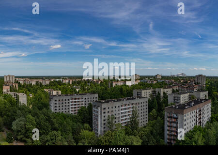 Looking over the abandoned town of Pripyat with the Chernobyl Nuclear power Station in the distance Stock Photo