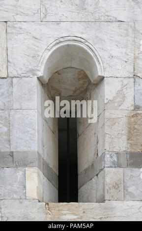 Small narrow window on old marble stone facade Stock Photo
