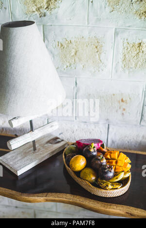Fruit plate with mango, passion fruit, mangosteen, dragonfruit on wooden table Stock Photo