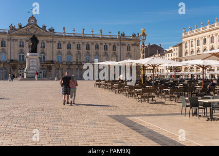 Nancy, France - 22 June 2018: Café terrace in the Place Stanislas square and Nepture fountain in the background. Stock Photo