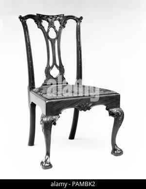 Side chair. Culture: American. Dimensions: 38 3/4 x 22 3/8 x 21 1/2 in. (98.4 x 56.8 x 54.6 cm). Date: 1760-90.  Chairs with trefoil-pierced splats enjoyed great popularity in Philadelphia. On the most richly embellished examples, such as this one, the stiles and crest rail are finely carved in alternating long and short lozenges. Museum: Metropolitan Museum of Art, New York, USA. Stock Photo