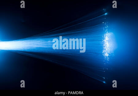 optical fibres dinamic flying from deep on technology background Stock Photo