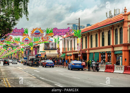 Singapore, January 12, 2018: Traffic on the street in the part of Singapore called Little India. Colorful old colonial houses and decoration over the  Stock Photo