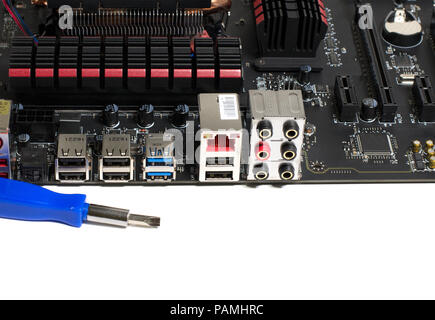 Kind of motherboard on the side with tools and parts for repair Stock Photo