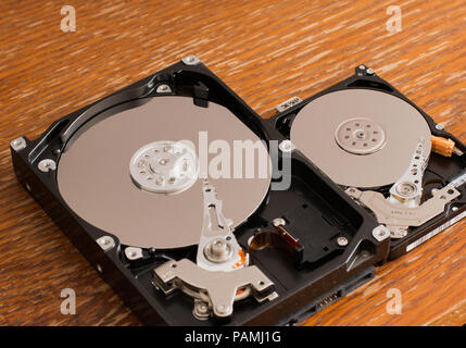 Disassembled hard drives on a wooden surface Stock Photo
