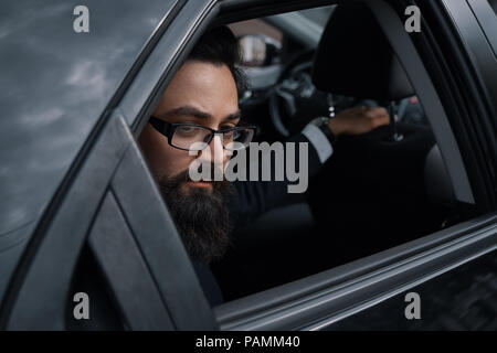 Close up portrair attractive young businessman in a car Stock Photo