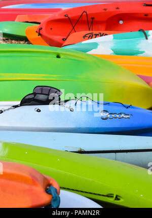 Brighton, United Kingdom - March 29 2018:   A Collection of Colourful Kayaks laying on Brighton beach Stock Photo