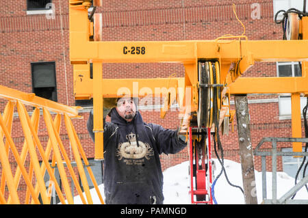 Setting up a tower crane in the winter in Rochester, NY. Stock Photo