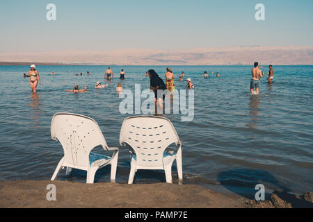 Two plastic chairs on the lake shores of the Dead Sea in Israel Stock Photo